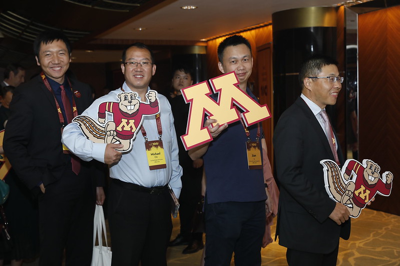 Carlson School alum pose with Block M and Goldy Gopher cutouts at an Asian Forum event.