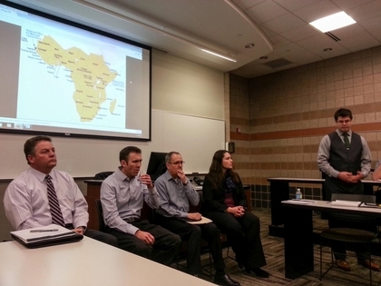 Panelists Sitting in Front of Africa Map