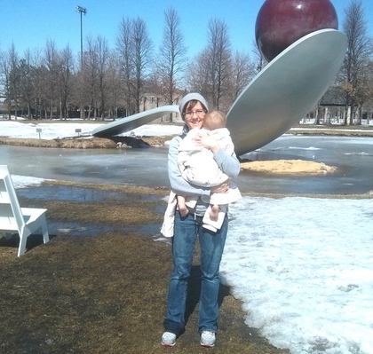 Heidi Holding Baby Posed in Front of the Cherry Spoon Sculpture