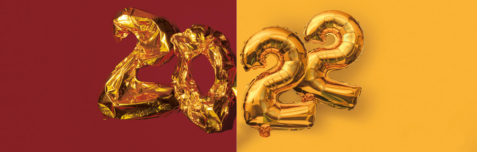 Deflated balloons of a 2 and 0 next to inflated balloons of 2 and 2 to spell out 2022