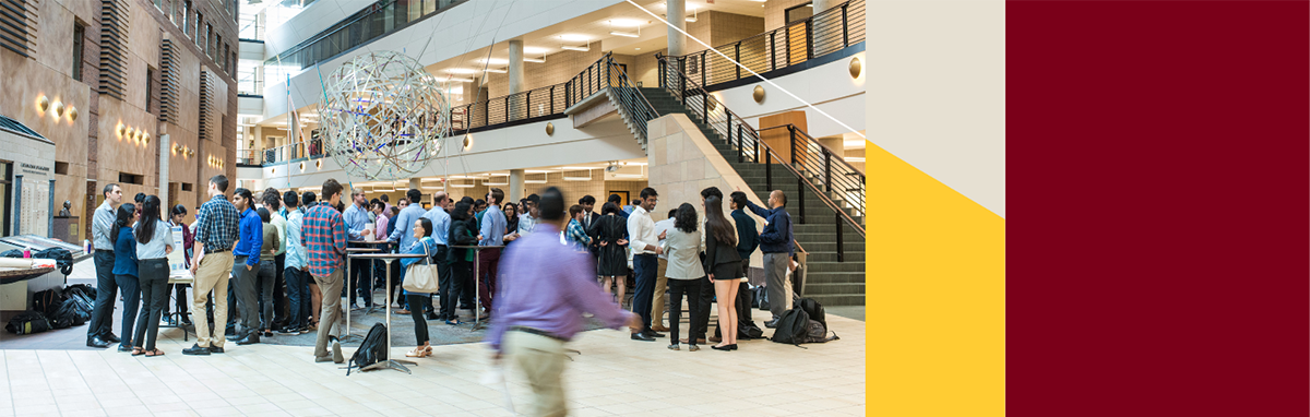 Carlson School Atrium with many students standing in groups talking