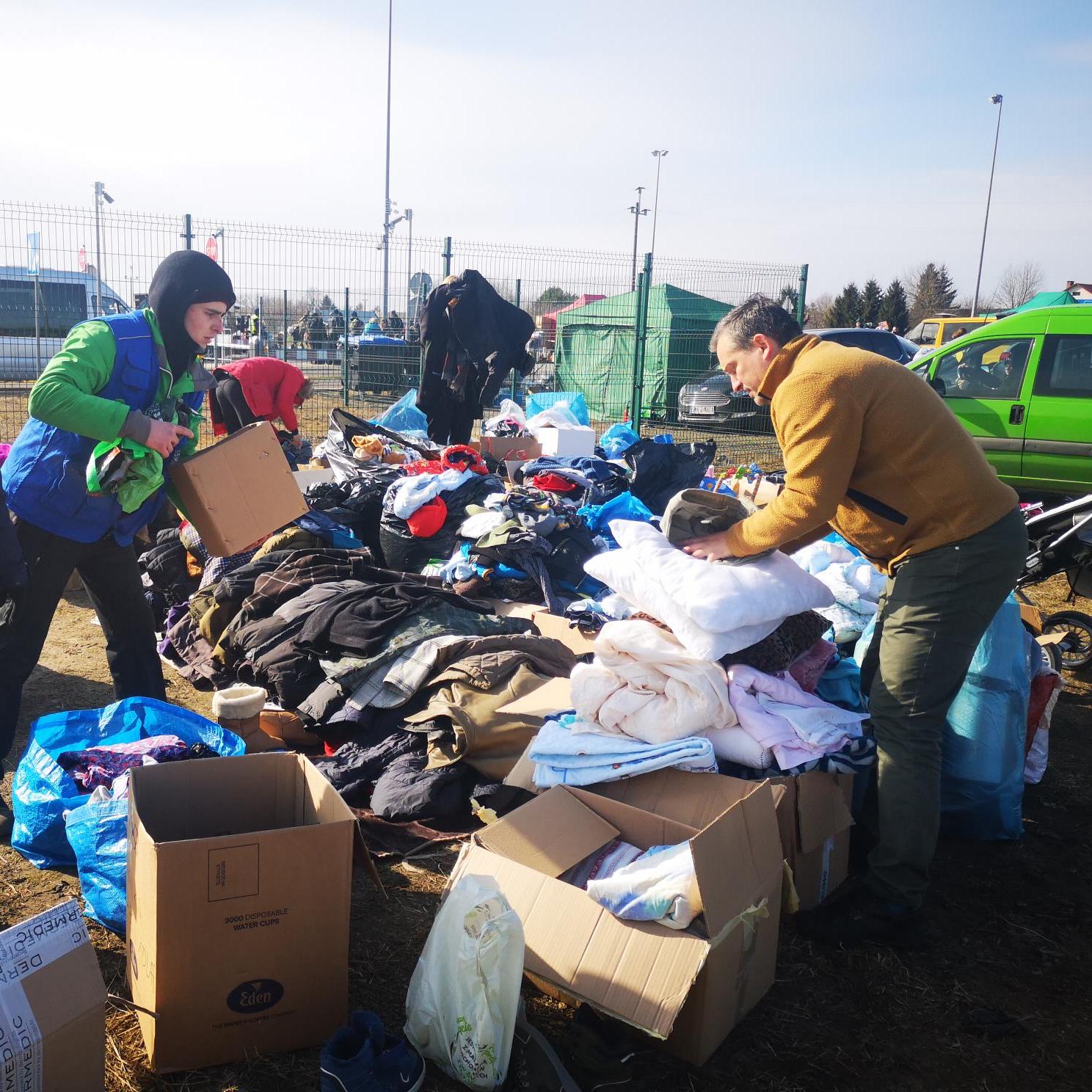 People provide aid for Ukrainian refugees at Polish border