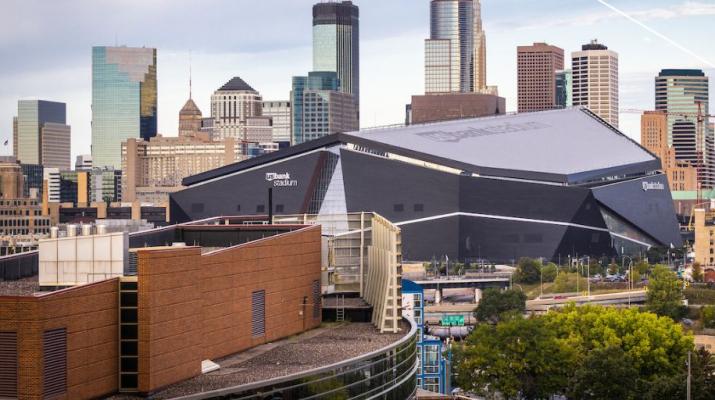 The Carlson School building against the backdrop of downtown Minneapolis.