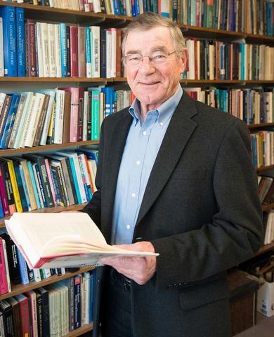 Andy Van de Ven poses with a book in a library