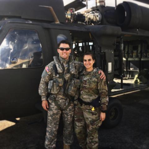 Sam and Lena Anderson in their Army uniforms in front of a helicopter