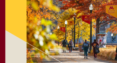 University of Minnesota students walking down campus street during Fall.