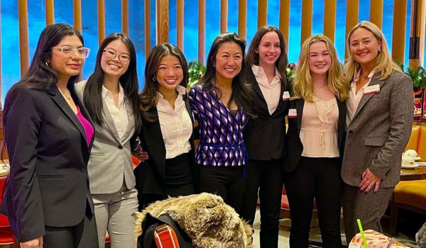 Seven women are pictured - six current Carlson School students and alum Mee Warren.