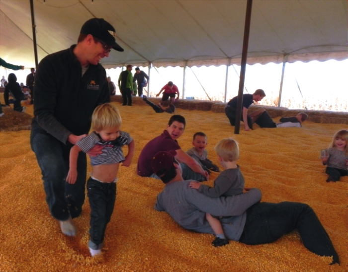 Family Playing in Corn Pit