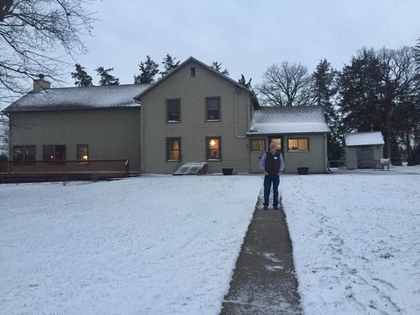 Man Standing in Front of House in Winter