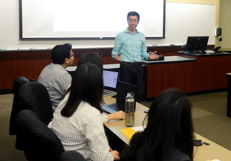 Professor De Liu teaching analytics class