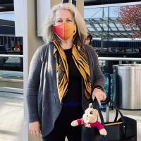 Susanna Gibbons poses outside the airport during her travels
