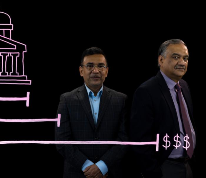 Anant Mishra and Kingshuk Sinha stand behind an illustration of a government building and a bar graph with growing dollar amounts.