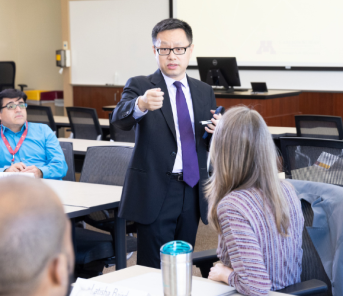 Yi Zhu teaches in a classroom of MBA students