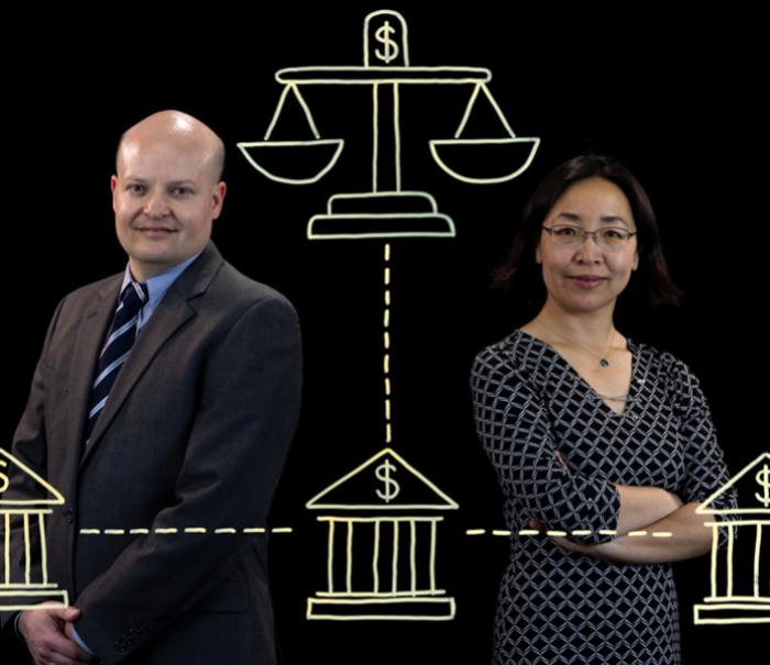 Michael Iselin and Helen Zhang stand behind an illustration depicting a network of banks and mutual funds.