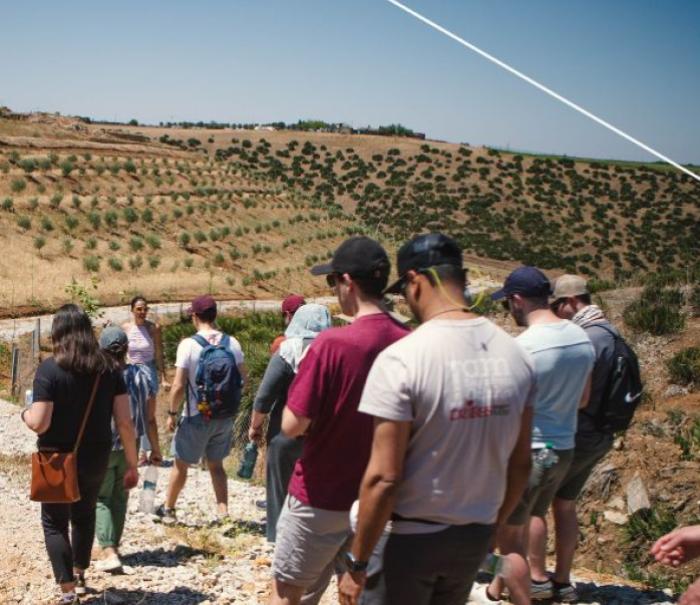 A group of graduate students tour farmland in Morocco.