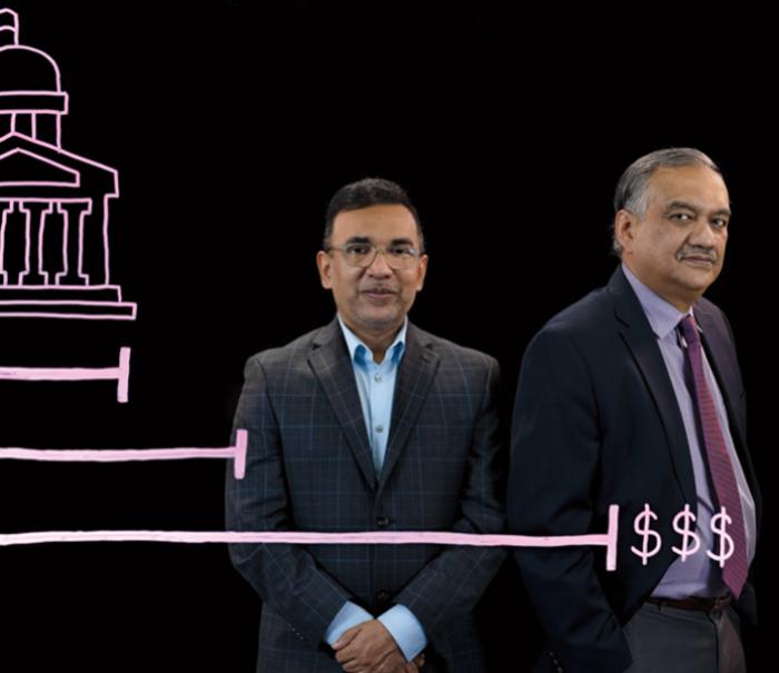 Anant Mishra and Kingshuk Sinha stand behind an illustration of a government building and a bar graph with growing dollar amounts.
