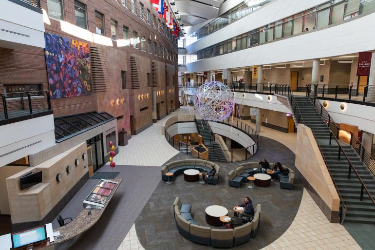 A wide shot of the Carlson School atrium, featuring space for collaboration.