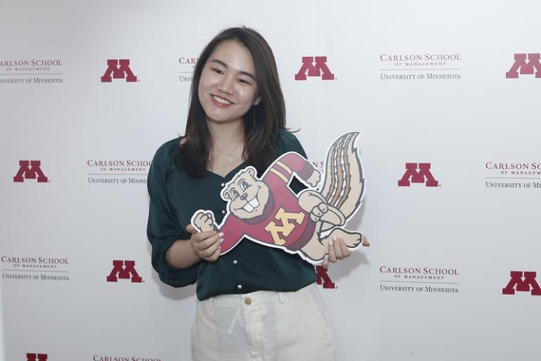Woman holding Goldy Gopher cutout
