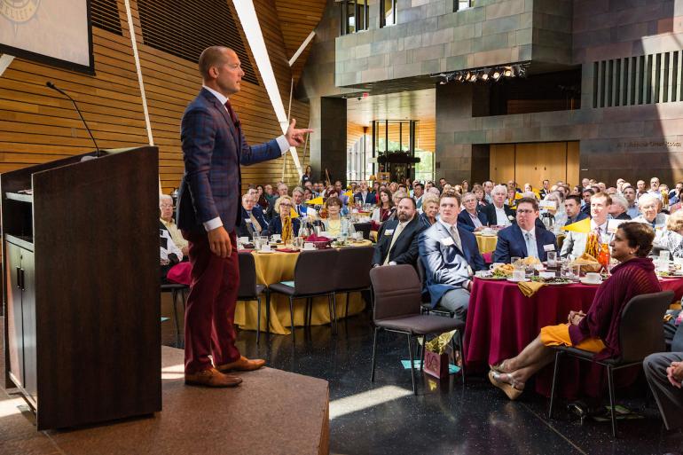 Gopher Football coach, PJ Fleck, speaks to a large crowd at the Carlson School's 1st Tuesday Speaker Series.
