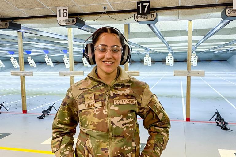 Senior Airman Lujana Thapa appears in uniform at a gun range during her deployment.