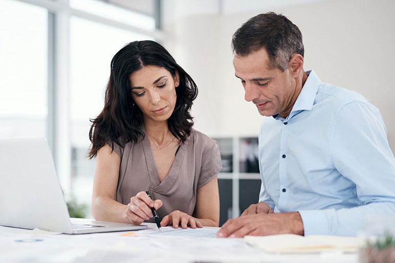 man and woman at table reviewing analytics for business