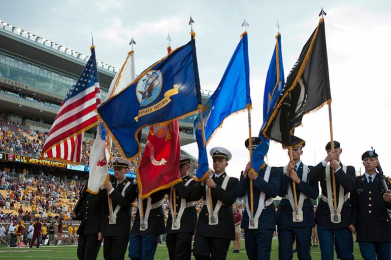 Military carrying flags