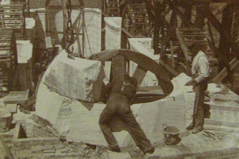 Workers setting rough stone in place, June 12,1899