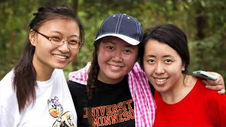 Three Asian American students posing together during a study abroad program