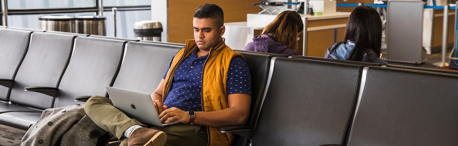 Man on computer in airport