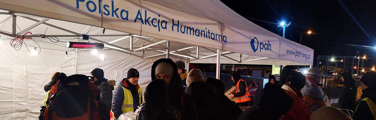 Polish Humanitarian Action staff and volunteers assist Ukrainian refugees at a border corssing in Poland.