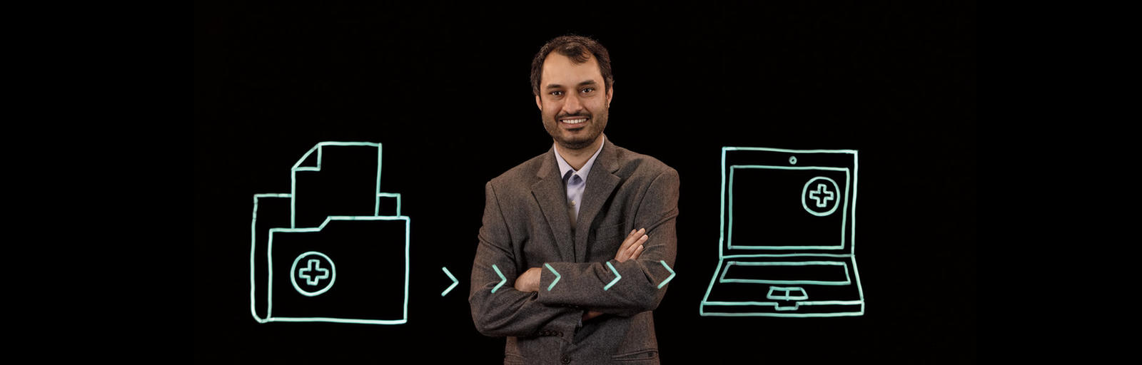 Kartik Ganju stands behind an illustrations of documents being transferred to a computer