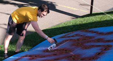 Keegan Masser paints a lawn for YardLogo.
