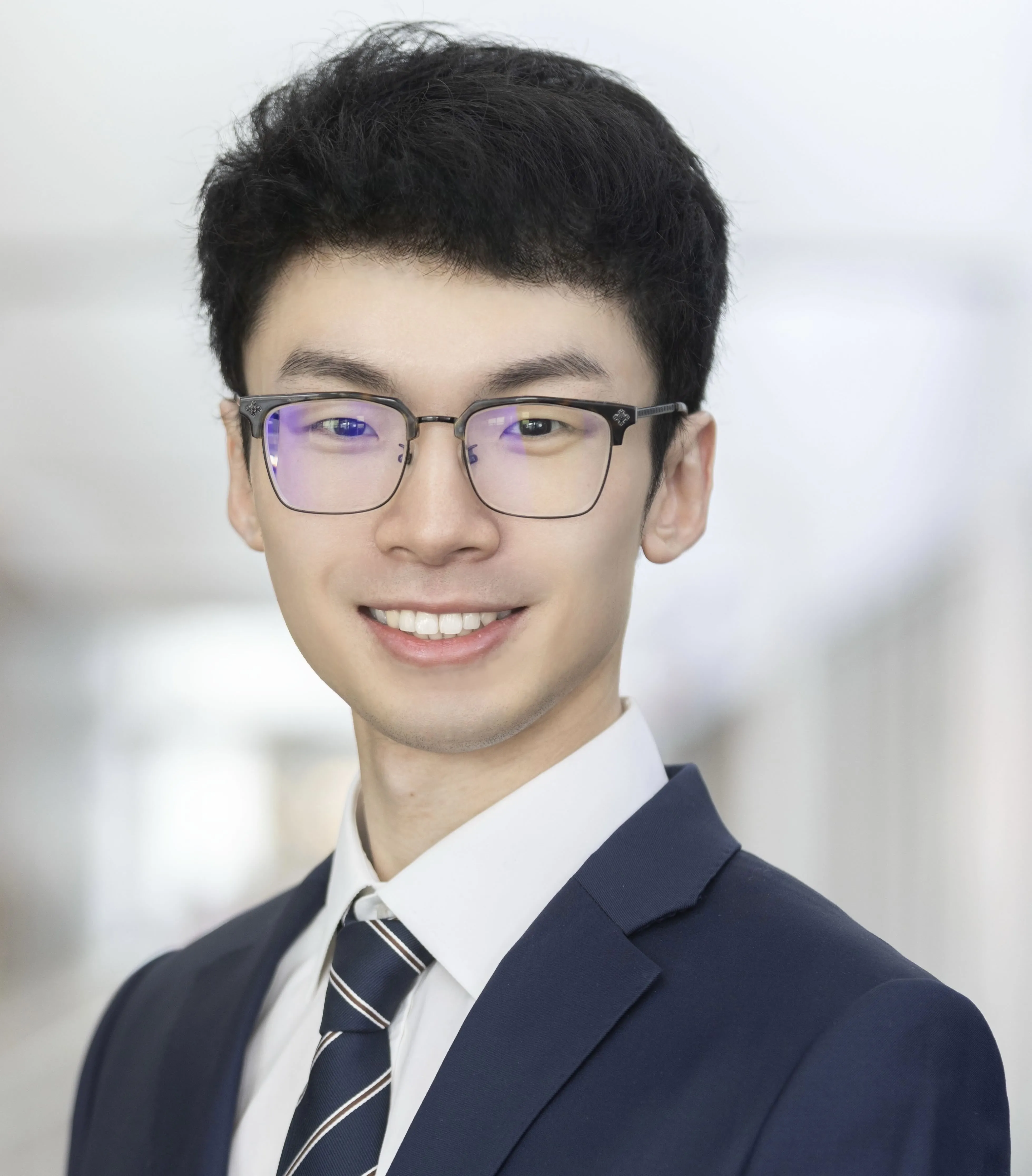This a profile picture for Liben Chen. He dresses in suits and ties. He smiles at you.