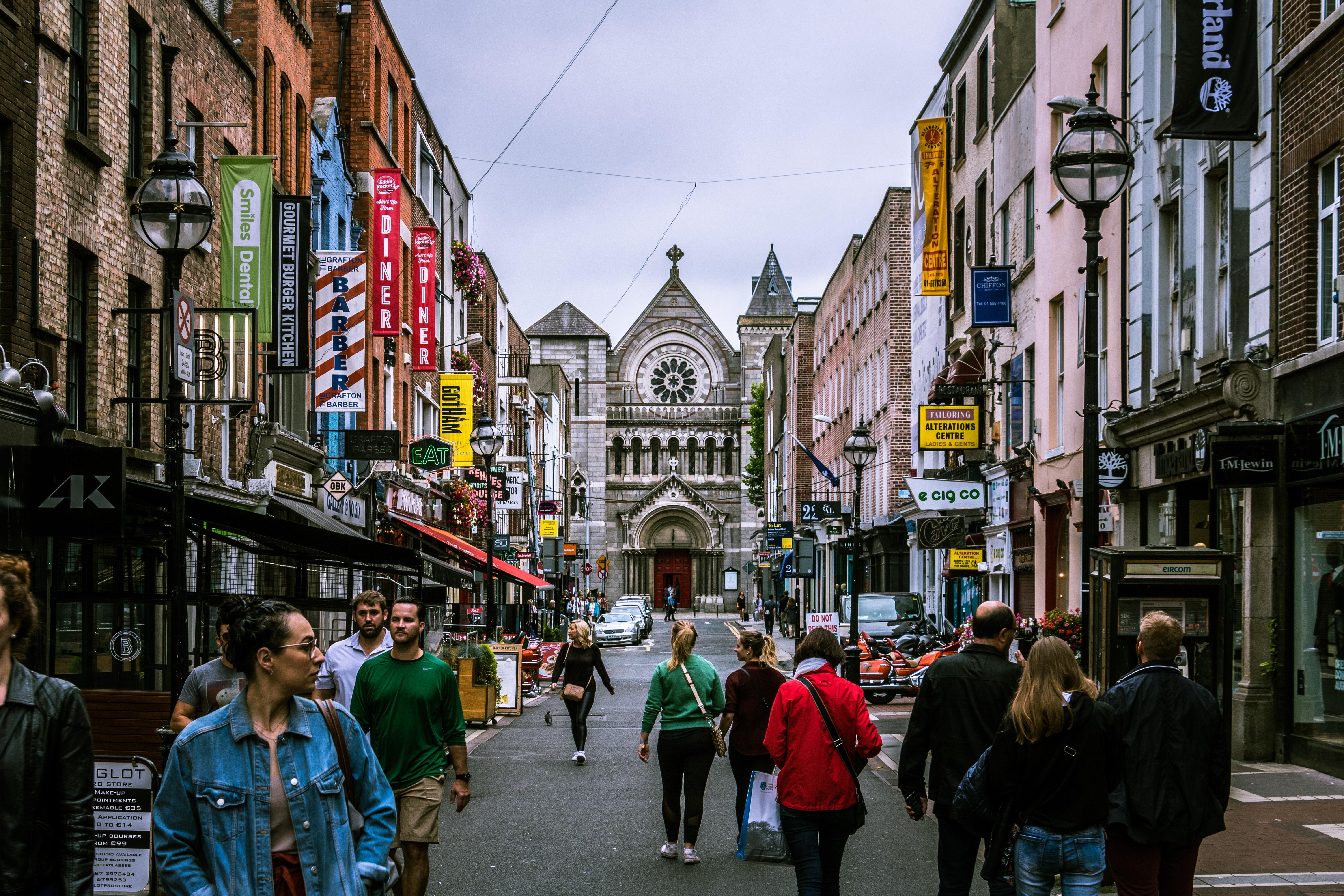 A group of people walking down a street in Dublin