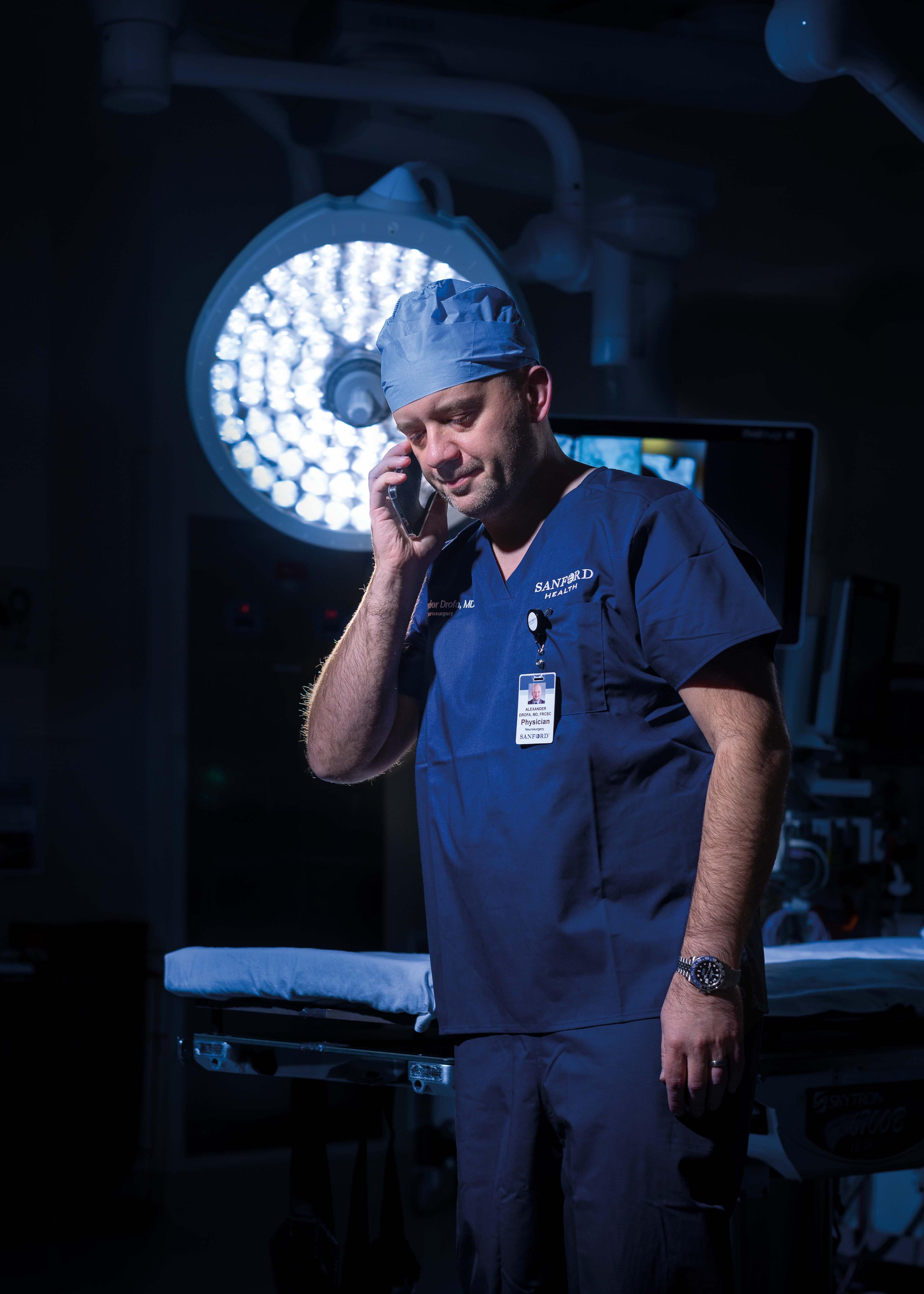 Dr. Drofa takes a call from the operating room