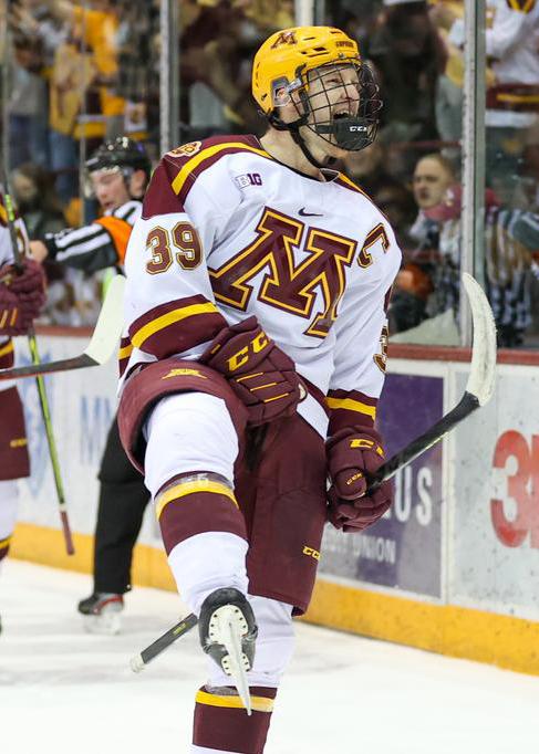 Ben Meyers celebrates after scoring a goal during a Gopher hockey game.
