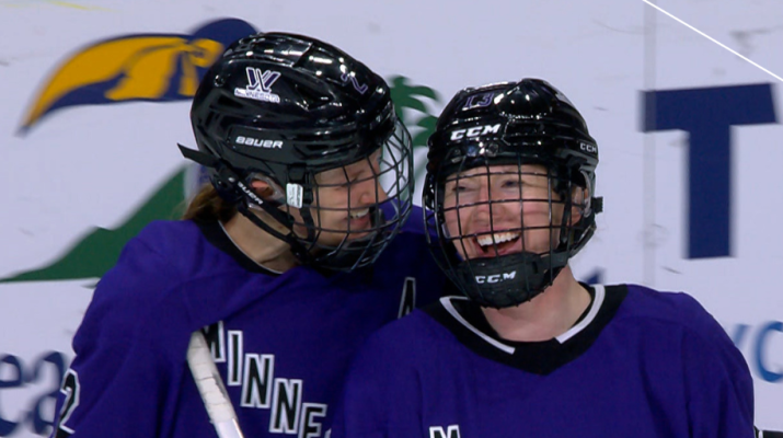 Carlson alum Grace Zumwinkle with teammate during hockey game.