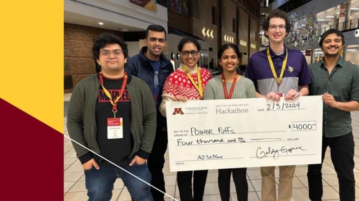 Two teams pose with oversize $4000 checks, celebrating their win for the Hackathon competition.