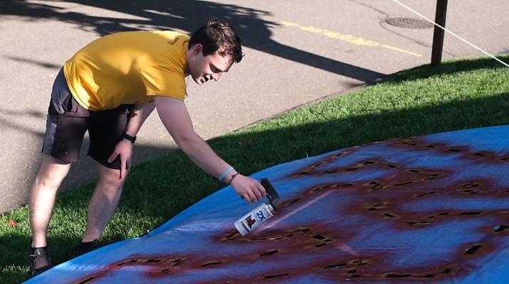 Keegan Masser paints a lawn for YardLogo.