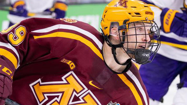 Ben Meyers skates for the Gophers during a hockey game.