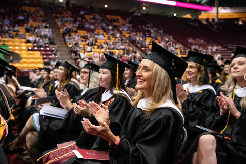 Graduate students applaud at the 2022 commencement ceremony