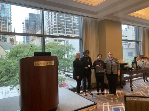 Ravi Bapna (second from left) and Sri Zaheer (second from right) accept innovation award from MABDA in Chicago
