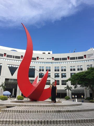 Jennifer Lien Will standing next to large sundial sculpture outside entrance of Hong Kong University of Science and Technology