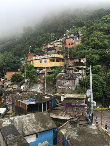 Shanty homes on side of mountain with fog in the background
