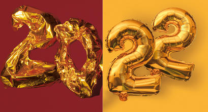 Deflated balloons of a 2 and 0 next to inflated balloons of 2 and 2 to spell out 2022