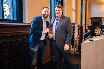 Michael Ramlet poses with his Entrepreneur of the Year award, alongside Dean Jamie Prenkert.