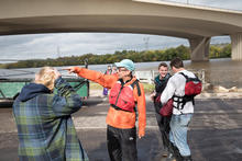 Steve Spruth teaches a class on entrepreneurial development during a canoe trip on the Mississippi River.