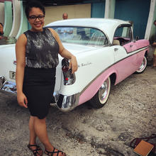 Shayla Thacker posing next to vintage car 
