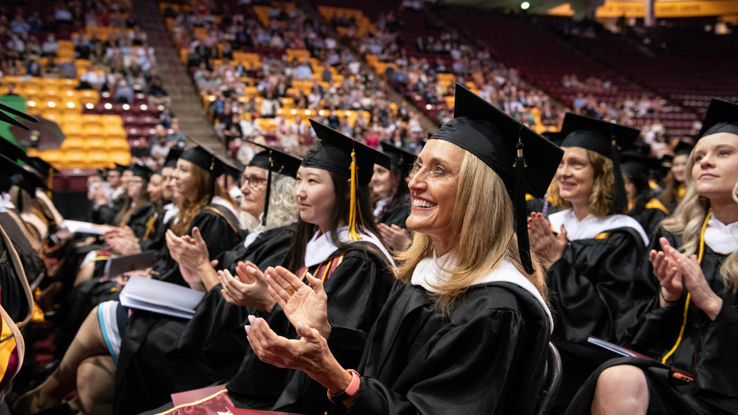 Graduate students applaud at the 2022 commencement ceremony
