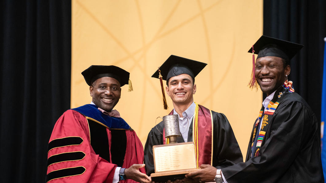 Parthsarthi Mishra and Chike Okonkwo are awarded the Tomato Can Loving Cup Award at the 2022 commencement ceremony